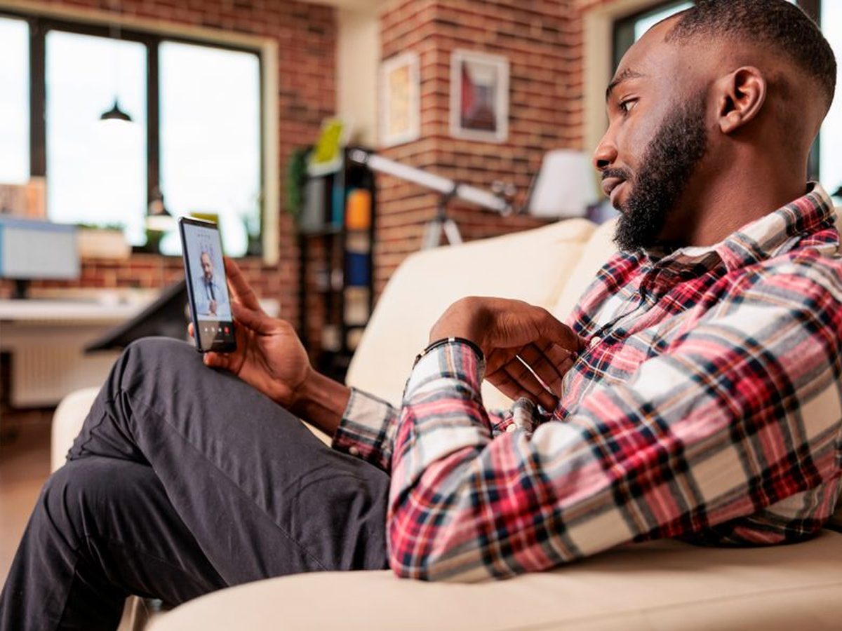 A man at home checking his health on his phone